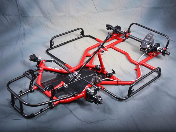 A red and black go-kart chassis on a gray background.